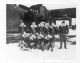 Gerald Donnelly with group in front of a plane - Unknown Date